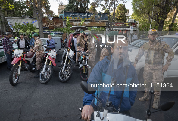 Members of the Islamic Revolutionary Guard Corps (IRGC) Special Forces are standing together at a celebration for the IRGC's unmanned aerial...