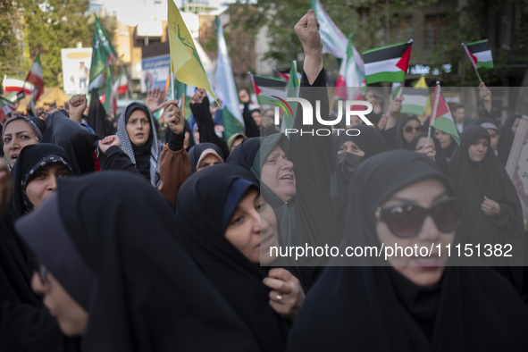 A veiled Iranian woman is shouting anti-Israeli and anti-U.S. slogans while celebrating the IRGC UAV and missile attack against Israel at Pa...