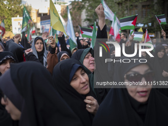 A veiled Iranian woman is shouting anti-Israeli and anti-U.S. slogans while celebrating the IRGC UAV and missile attack against Israel at Pa...