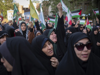 A veiled Iranian woman is shouting anti-Israeli and anti-U.S. slogans while celebrating the IRGC UAV and missile attack against Israel at Pa...