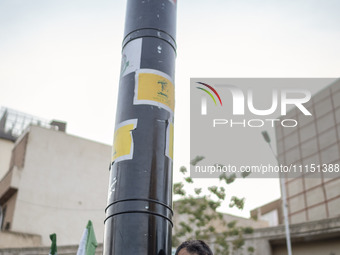 An unidentified man is holding a model of Iran's first-ever hypersonic missile, Fattah, during a gathering to celebrate the IRGC UAV and mis...