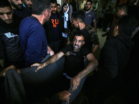 Palestinians are mourning the death of loved ones following an Israeli bombardment in Maghazi in the central Gaza Strip, on April 16, 2024,...