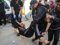 Palestinians are mourning the death of loved ones following an Israeli bombardment in Maghazi in the central Gaza Strip, on April 16, 2024,...