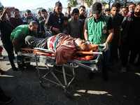 Palestinians are mourning the death of loved ones following an Israeli bombardment in Maghazi in the central Gaza Strip, on April 16, 2024,...