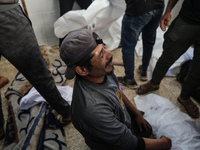 Palestinians are mourning the death of loved ones following an Israeli bombardment in Maghazi in the central Gaza Strip, on April 16, 2024,...