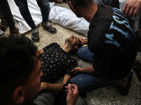 Palestinians are mourning the death of loved ones following an Israeli bombardment in Maghazi in the central Gaza Strip, on April 16, 2024,...