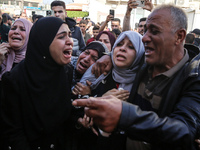 Palestinians are reacting next to their relatives who have been killed in an Israeli strike as they arrive at Al-Aqsa hospital, amid the ong...