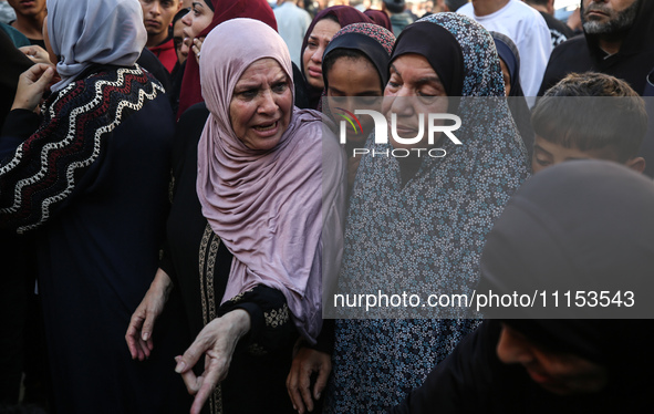 Palestinians are mourning the death of loved ones following an Israeli bombardment in Maghazi in the central Gaza Strip, on April 16, 2024,...