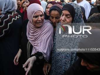 Palestinians are mourning the death of loved ones following an Israeli bombardment in Maghazi in the central Gaza Strip, on April 16, 2024,...