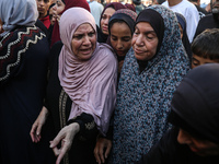 Palestinians are mourning the death of loved ones following an Israeli bombardment in Maghazi in the central Gaza Strip, on April 16, 2024,...