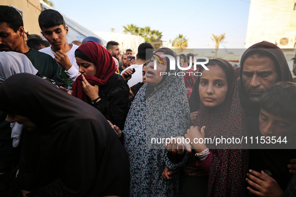 Palestinians are mourning the death of loved ones following an Israeli bombardment in Maghazi in the central Gaza Strip, on April 16, 2024,...