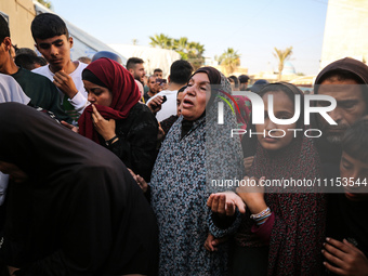 Palestinians are mourning the death of loved ones following an Israeli bombardment in Maghazi in the central Gaza Strip, on April 16, 2024,...