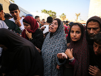 Palestinians are mourning the death of loved ones following an Israeli bombardment in Maghazi in the central Gaza Strip, on April 16, 2024,...