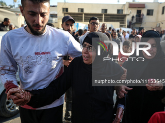 Palestinians are mourning the death of loved ones following an Israeli bombardment in Maghazi in the central Gaza Strip, on April 16, 2024,...