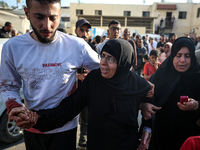 Palestinians are mourning the death of loved ones following an Israeli bombardment in Maghazi in the central Gaza Strip, on April 16, 2024,...