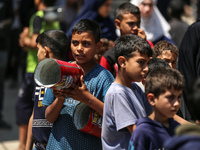 Displaced Palestinians are gathering to receive food at a donation point in Deir al-Balah, central Gaza Strip, on April 16, 2024, amid ongoi...