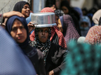 Displaced Palestinians are gathering to receive food at a donation point in Deir al-Balah, central Gaza Strip, on April 16, 2024, amid ongoi...