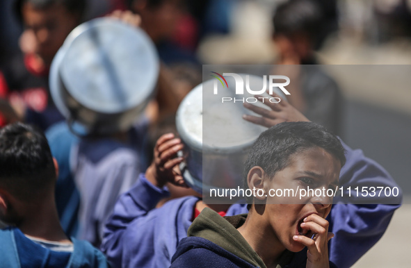 Displaced Palestinians are gathering to receive food at a donation point in Deir al-Balah, central Gaza Strip, on April 16, 2024, amid ongoi...