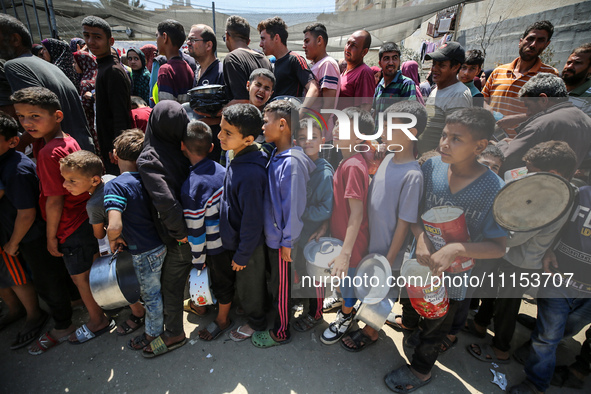 Displaced Palestinians are gathering to receive food at a donation point in Deir al-Balah, central Gaza Strip, on April 16, 2024, amid ongoi...