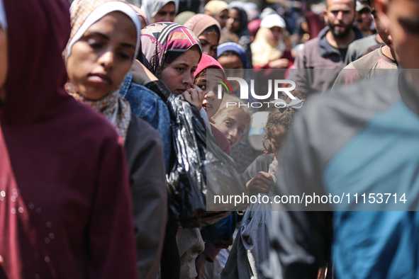 Displaced Palestinians are gathering to receive food at a donation point in Deir al-Balah, central Gaza Strip, on April 16, 2024, amid ongoi...