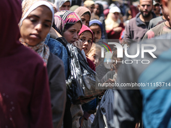 Displaced Palestinians are gathering to receive food at a donation point in Deir al-Balah, central Gaza Strip, on April 16, 2024, amid ongoi...