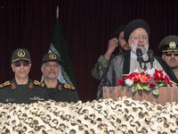 Iranian President Ebrahim Raisi (C) is addressing attendees at a military parade marking Iran's Army Day anniversary at an Army military bas...