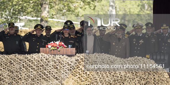 Iranian President Ebrahim Raisi (C) is attending a military parade to mark Iran's Army Day anniversary at an Army military base in Tehran, I...