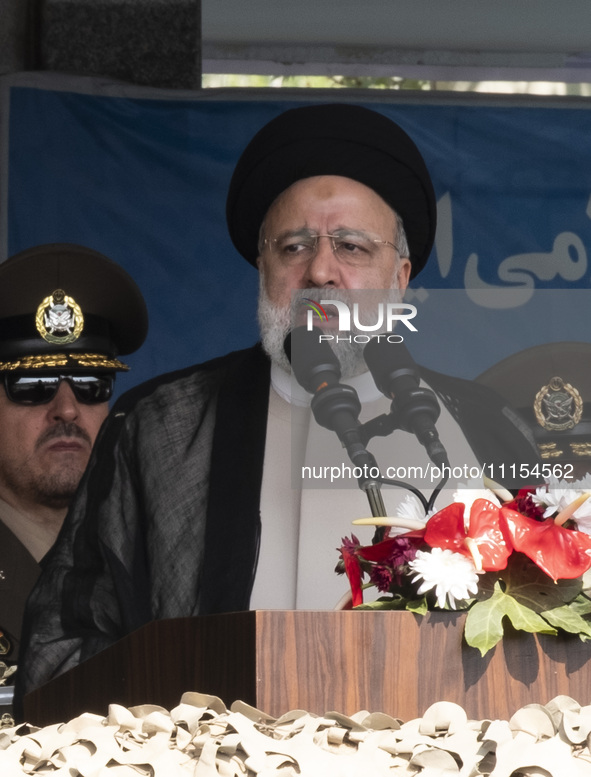 Iranian President Ebrahim Raisi is addressing attendees at a military parade marking Iran's Army Day anniversary at an Army military base in...