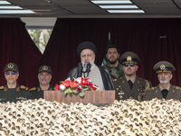 Iranian President Ebrahim Raisi (C) is addressing attendees at a military parade marking Iran's Army Day anniversary at an Army military bas...