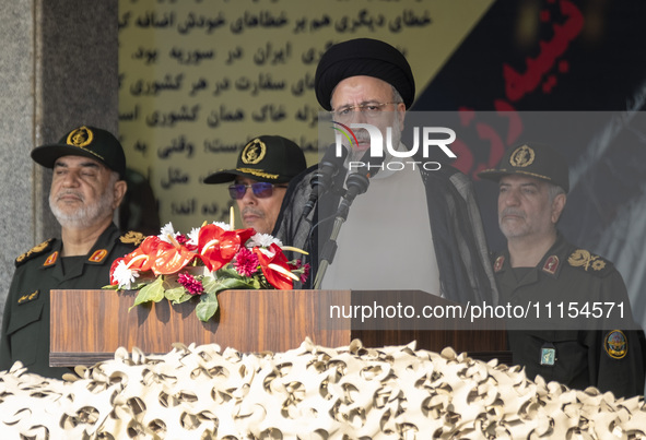 Iranian President Ebrahim Raisi (2nd R) is addressing attendees at a military parade marking Iran's Army Day anniversary at an Army military...