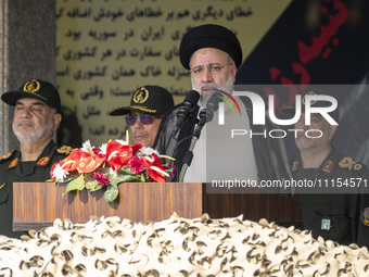 Iranian President Ebrahim Raisi (2nd R) is addressing attendees at a military parade marking Iran's Army Day anniversary at an Army military...