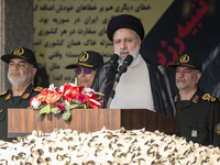 Iranian President Ebrahim Raisi (2nd R) is addressing attendees at a military parade marking Iran's Army Day anniversary at an Army military...