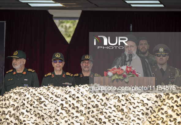 Iranian President Ebrahim Raisi (3rd R) is addressing attendees at a military parade marking Iran's Army Day anniversary at an Army military...