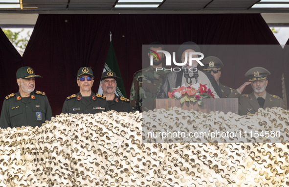 Iranian President Ebrahim Raisi (3rd R) is addressing attendees at a military parade marking Iran's Army Day anniversary at an Army military...