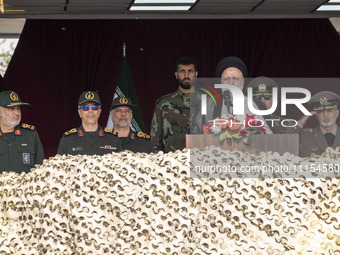 Iranian President Ebrahim Raisi (3rd R) is addressing attendees at a military parade marking Iran's Army Day anniversary at an Army military...