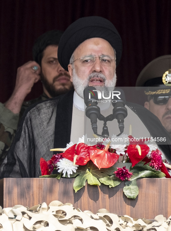 Iranian President Ebrahim Raisi is addressing attendees at a military parade marking Iran's Army Day anniversary at an Army military base in...