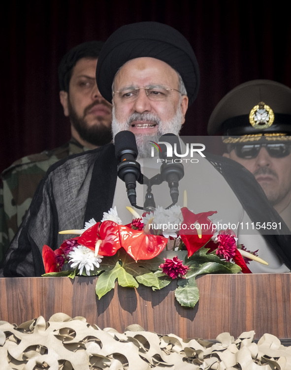 Iranian President Ebrahim Raisi is addressing attendees at a military parade marking Iran's Army Day anniversary at an Army military base in...