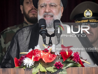 Iranian President Ebrahim Raisi is addressing attendees at a military parade marking Iran's Army Day anniversary at an Army military base in...