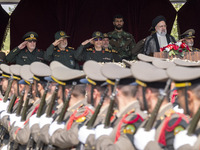 Iranian President Ebrahim Raisi (2nd R) is standing with the Islamic Revolutionary Guard Corps (IRGC) commanders (L) and an Iranian Army com...