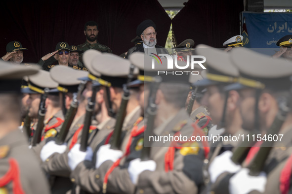 Iranian President Ebrahim Raisi (C) is attending a military parade to mark Iran's Army Day anniversary at an Army military base in Tehran, I...