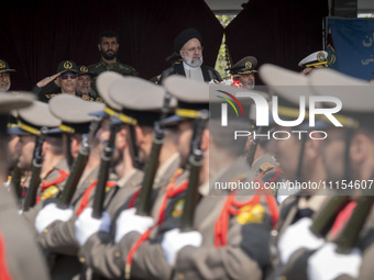 Iranian President Ebrahim Raisi (C) is attending a military parade to mark Iran's Army Day anniversary at an Army military base in Tehran, I...