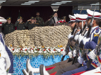 Iranian President Ebrahim Raisi is standing with the Islamic Revolutionary Guard Corps (IRGC) commanders while attending a military parade m...