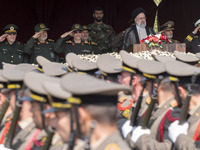 Iranian President Ebrahim Raisi is standing with the Islamic Revolutionary Guard Corps (IRGC) commanders on his left, and Iranian Army comma...