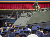 Iranian President Ebrahim Raisi (L) is speaking with an Iranian Army Major General, while a military personnel is saluting and standing on a...