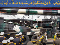 Iranian President Ebrahim Raisi (4th L) is looking at an Iranian missile being carried by a truck while standing with the Islamic Revolution...