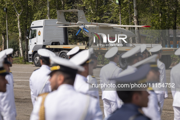 A truck is carrying an Iranian-made Unmanned Aerial Vehicle (UAV) during a military parade marking Iran's Army Day anniversary at an Army mi...