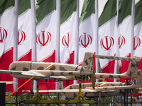 A truck is carrying Iranian-made Unmanned Aerial Vehicles (UAVs) past Iranian flags during a military parade marking the anniversary of Iran...