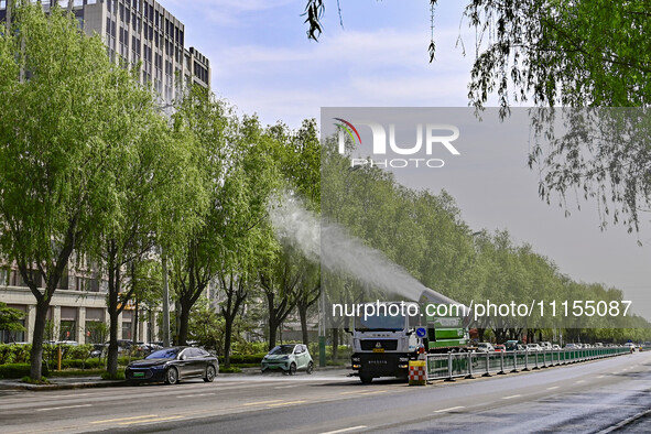 A fog cannon truck is carrying out spraying operations on Jiangjunshan Road in Qingzhou, China, on April 17, 2024. Every April and May is th...