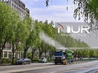 A fog cannon truck is carrying out spraying operations on Jiangjunshan Road in Qingzhou, China, on April 17, 2024. Every April and May is th...