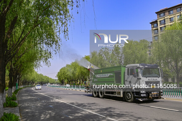 A fog cannon truck is carrying out spraying operations on Jiangjunshan Road in Qingzhou, China, on April 17, 2024. Every April and May is th...